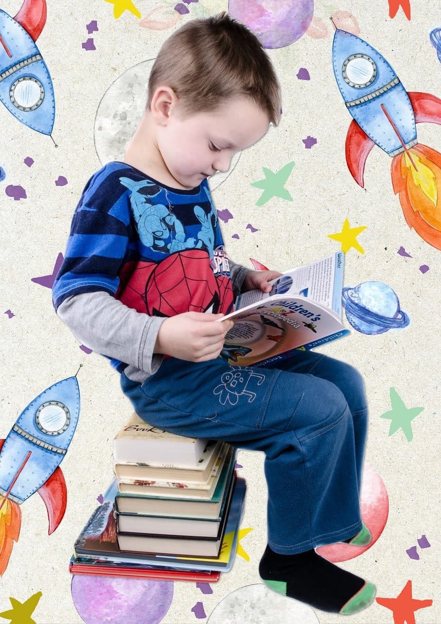Kid sitting down and reading a book
